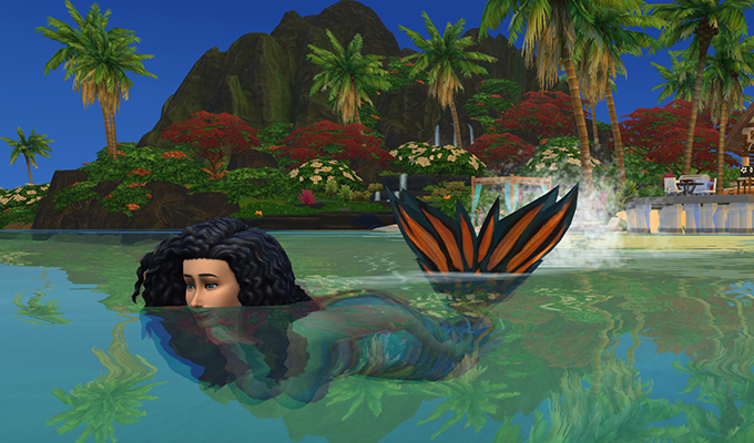 A mermaid gracefully swimming through clear blue water, her shimmering tail catching the light.