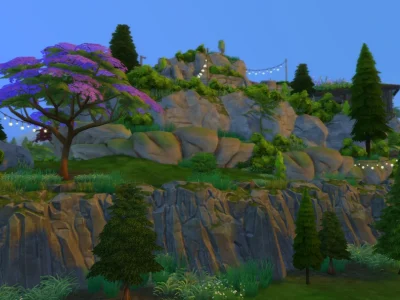 An upper cliff view of a fully explorable mountain build in The Sims 4 with layered rock formations, lush greenery, string lights, trees, and walkable paths leading toward the summit.