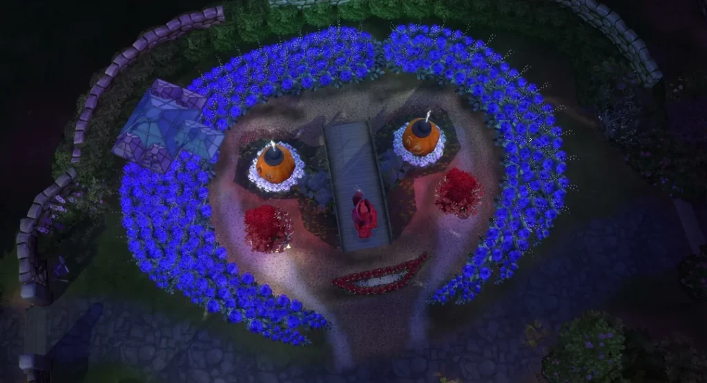 Overhead nighttime view of a Sims 4 garden designed to resemble Coraline’s face, made from glowing purple flowers, red shrubs, pumpkin-like eyes, and curved stone walls forming a circular floral design.