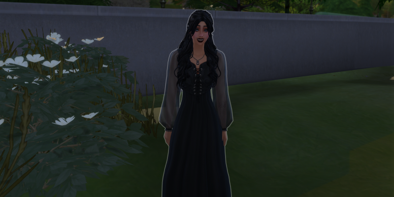 Gothic female Sim in a black dress standing outdoors near plants and greenery.
