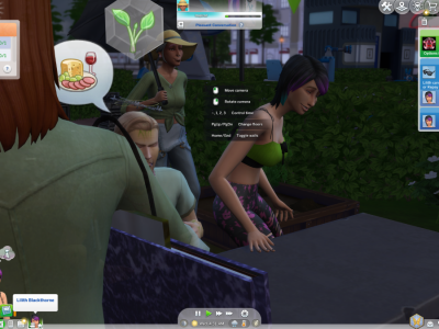 Sims in The Sims 4 having a conversation at an outdoor gardening table in a city park at night, with Lilith Blackthorne visible in the game interface.
