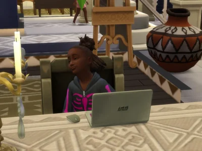 A Sims 4 child Sim sitting at a desk with a laptop, smiling proudly, with candles and home decor visible around them.
